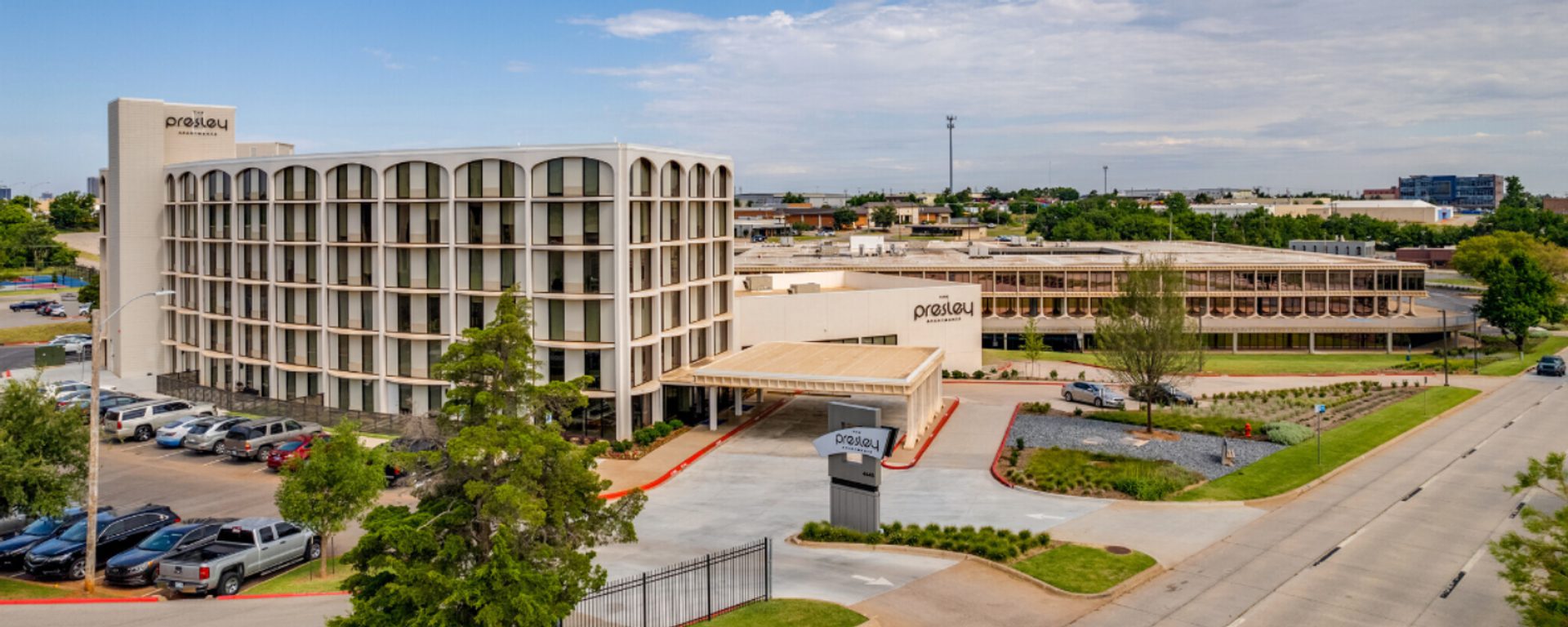 Exterior photo on a warm, sunny day of The Presley Luxury Apartments in OKC.